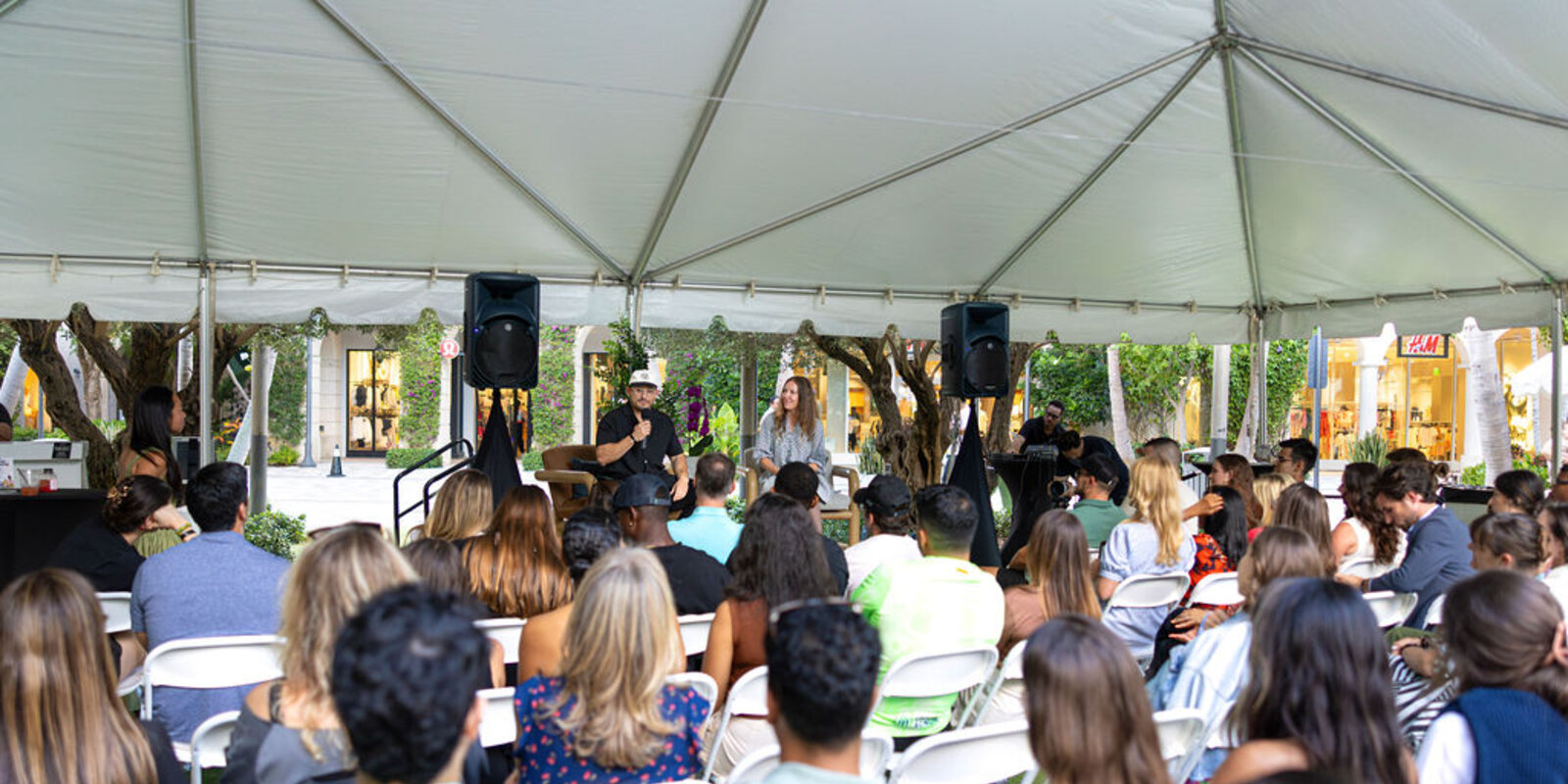 audience watching discussion between two people on a stage