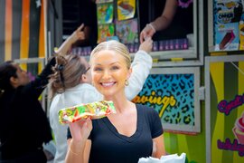 woman holding an ice cream bar and smiling